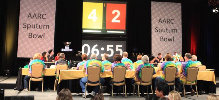 People sitting at tables participating in the AARC Sputum Bowl