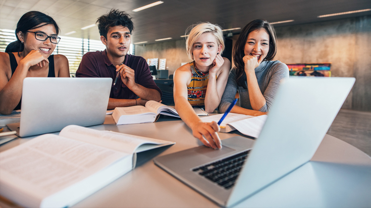 Image of students looking at computer
