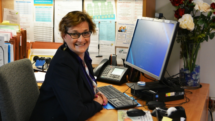Photo of Lisa Houle, working at desk