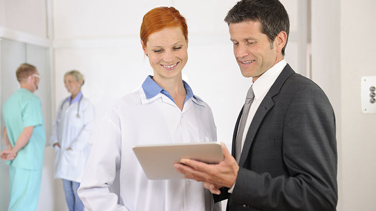 image of man in suit talking with doctor