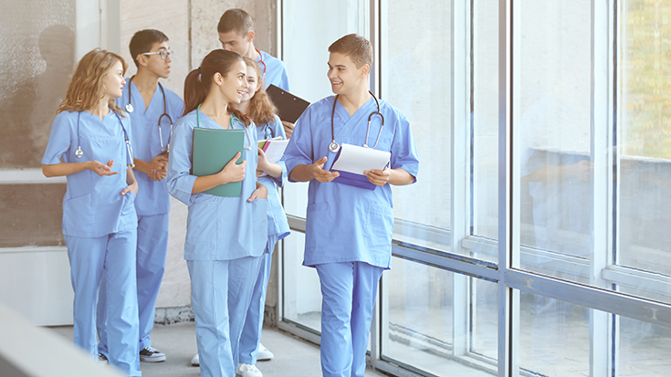 image of medical students walking down hall