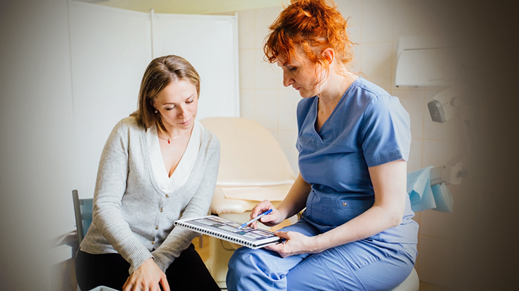 Image of nurse speaking with woman
