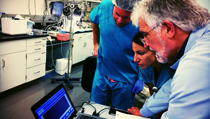 Image of three respiratory therapists conducting research together