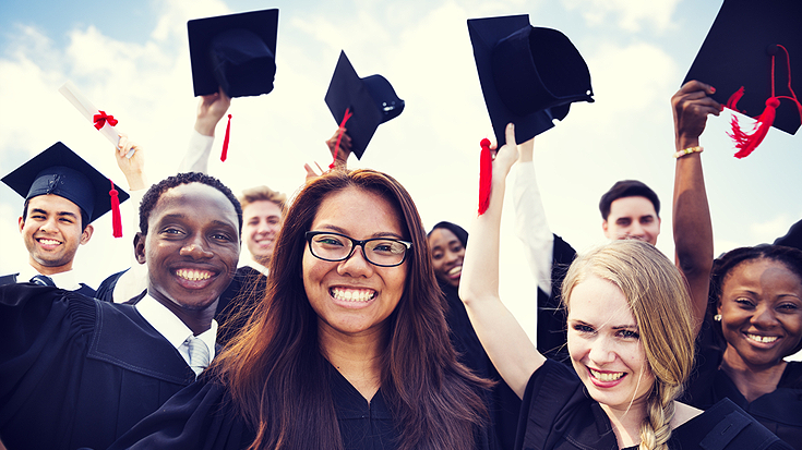 Image of graduates throwing their caps