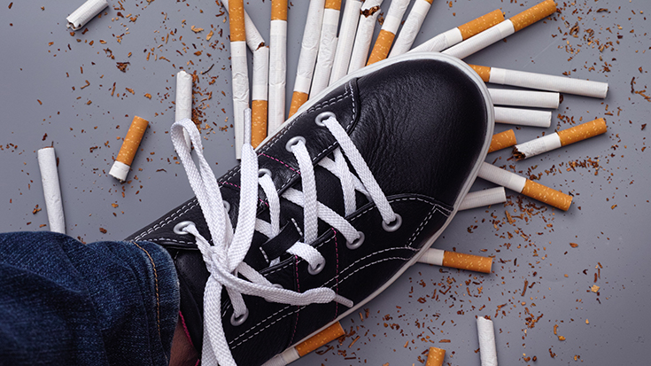 photo of shoe stomping cigarettes in an effort to stop tobacco use