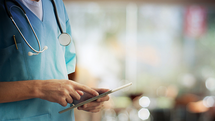 image of medical professional using electronic tablet