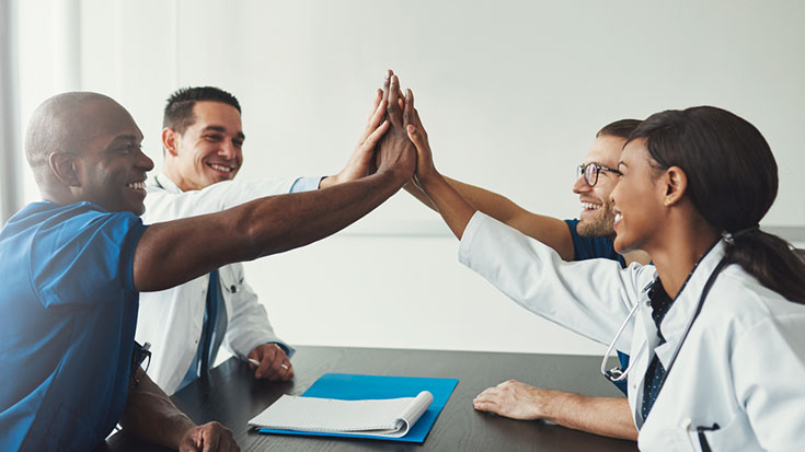 Image of doctors high-fiving each other