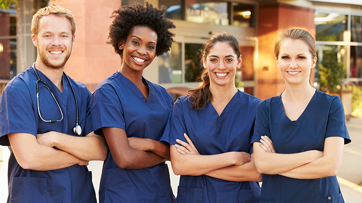 image of medical professionals standing outside building