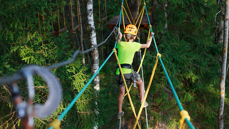 image of child working through ropes course