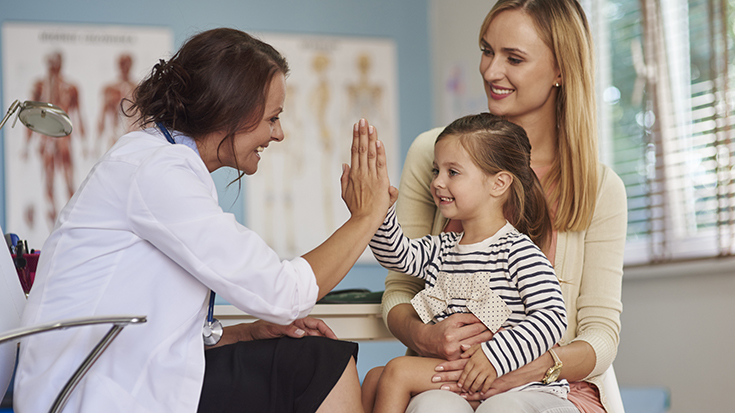 image of doctor working with mother and daughter