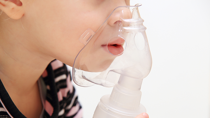 image of child holding facemask for breathing