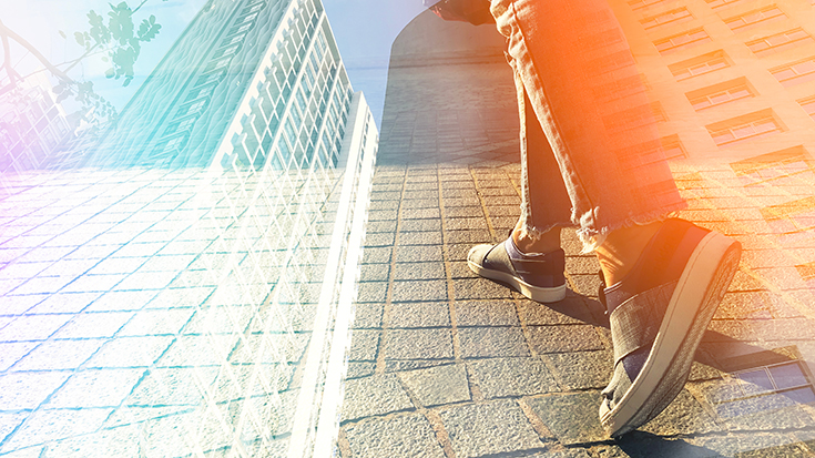 image of person walking toward city 