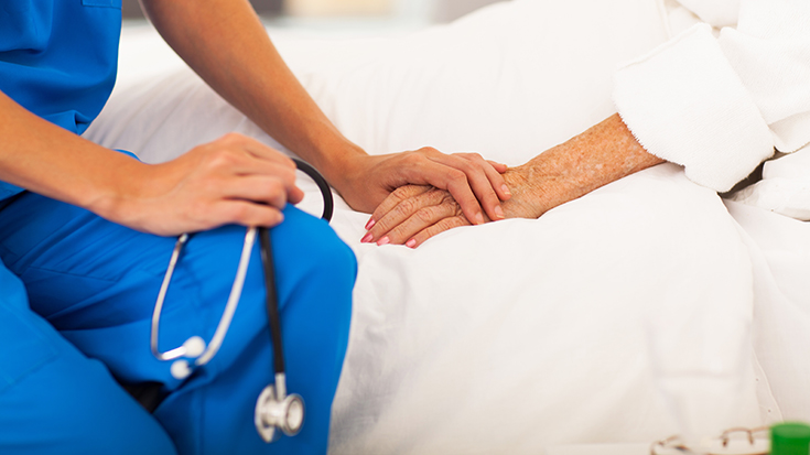 image of medial professional holding hands with patient