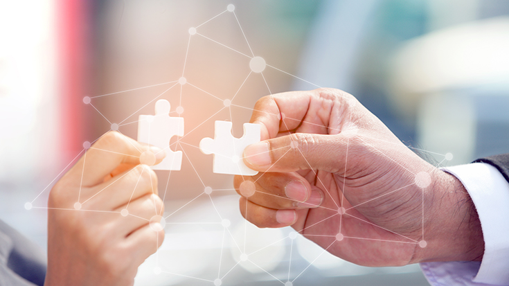 image of two people connecting two jigsaw puzzles