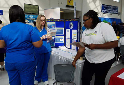 image of GSRC students and future volunteer at fair
