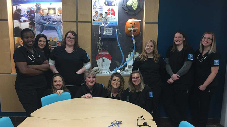 Group photo of GFC RT students in front of their RC Week Display