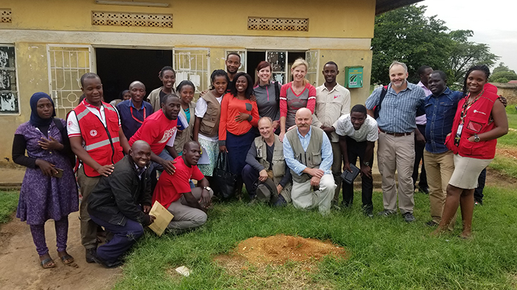 image of Frank Freihaut, fifth from the right on the front row, is seen here with his colleagues from the Nebraska Bio-containment Unit and some of the health care professionals they helped to train in infectious disease measures during a trip to Uganda last August.