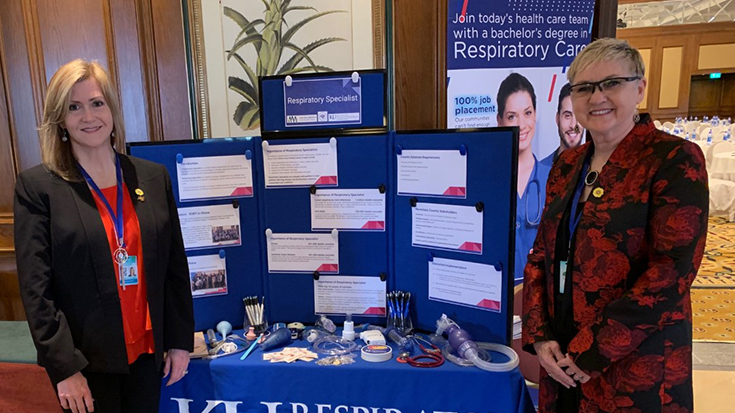 Photo of Lisa Trujillo (left) and Karen Schell (right) hosting a booth at the African Union Summit