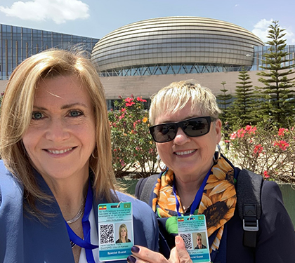 photo of Lisa Trujillo (left) and Karen Schell (right) showing off their official badges at the African Union Summit