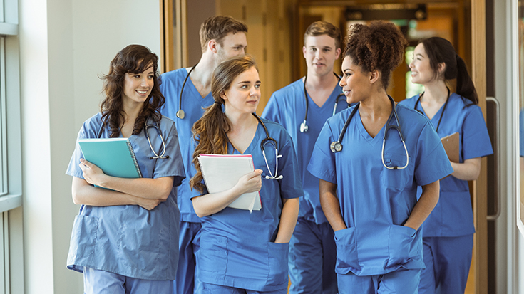 image of group of young medical professionals walking down hall