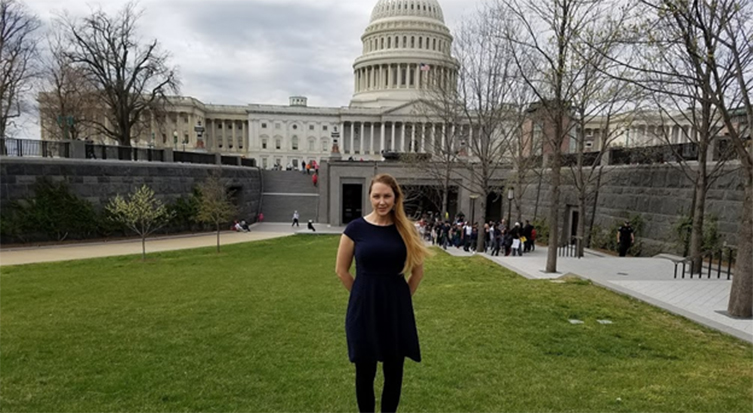 photo of Mandy De Vries standing in front of U.S. Capitol