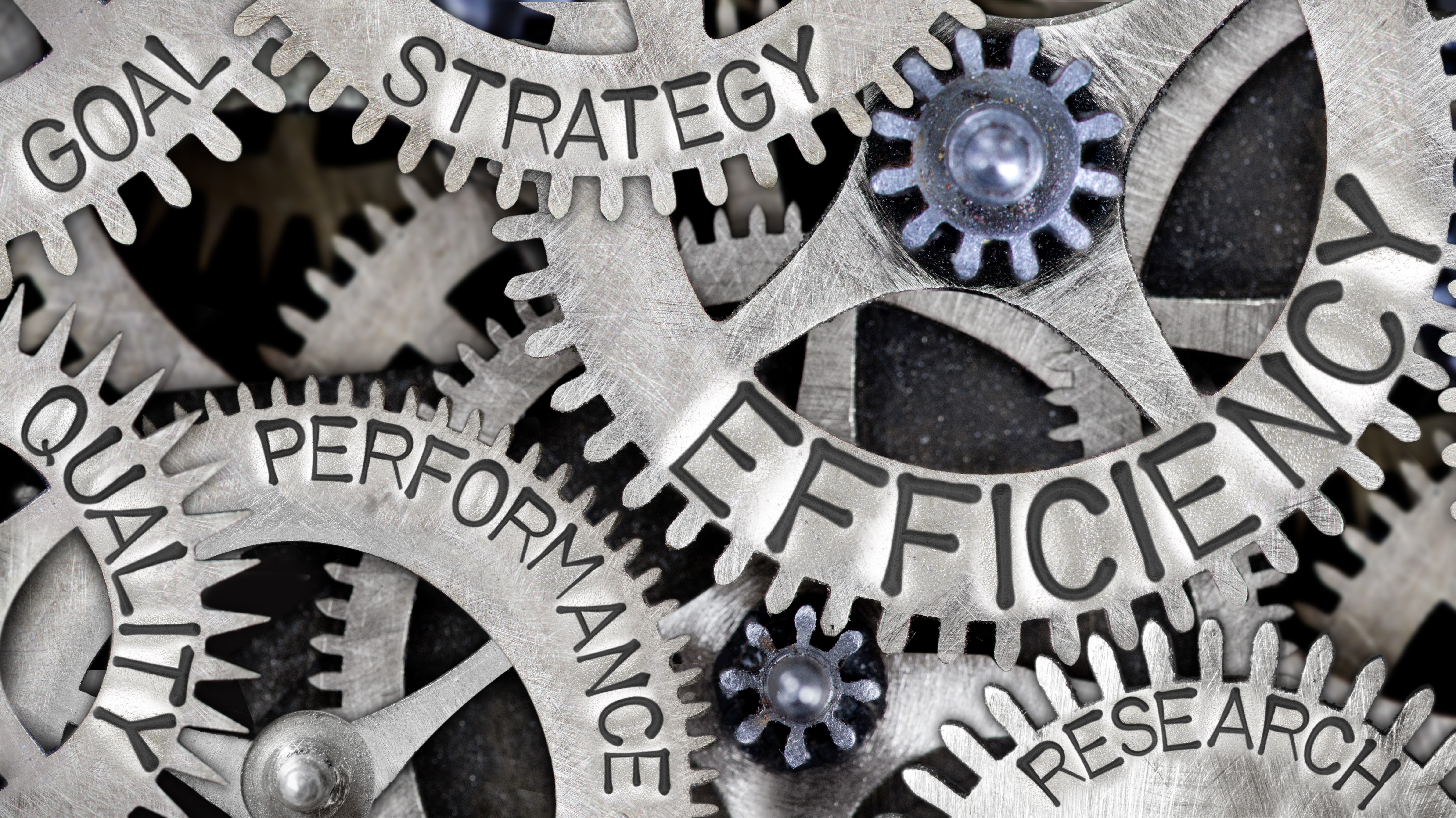 image of gear cogs with EFFECIENCY and other business terms written on them