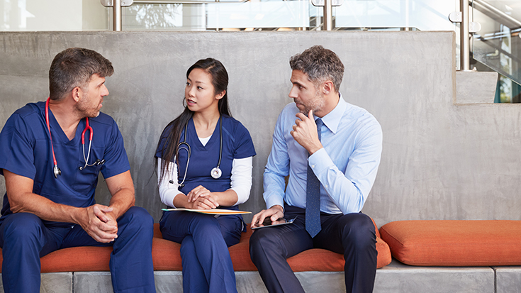 Three doctors having a conversation