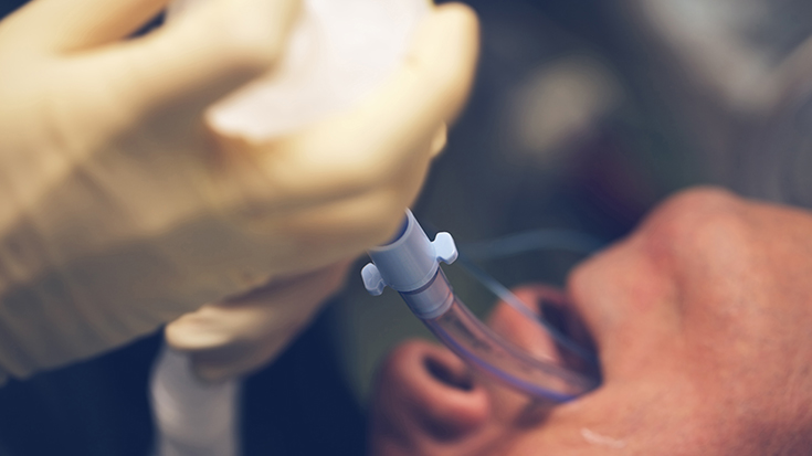 close up image of medical professional intubating a patient