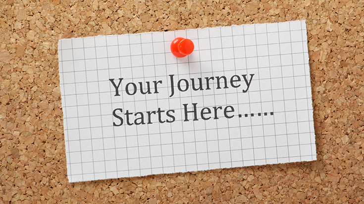 image of corkboard with note tacked on that reads Your Journey Starts Here