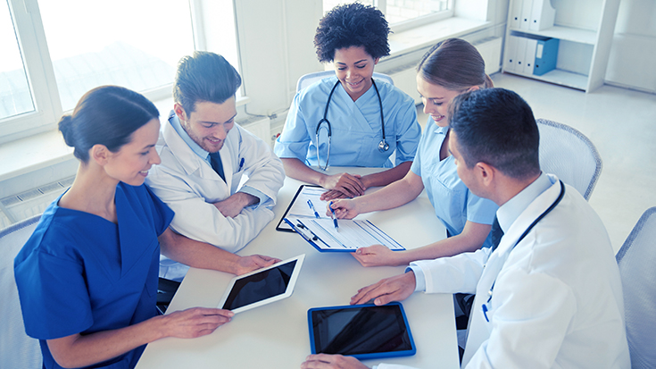 Image of doctors and nurses talking at table