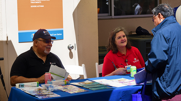photo of El Camino Health team members hosting an information table at the community health fair