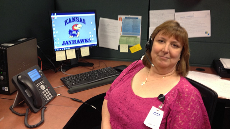 Jeri Whooley sitting at her desk at Centene