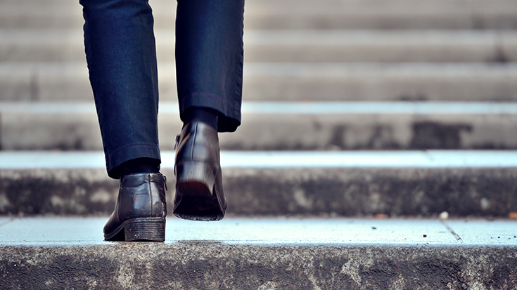 photo of man walking up stairs