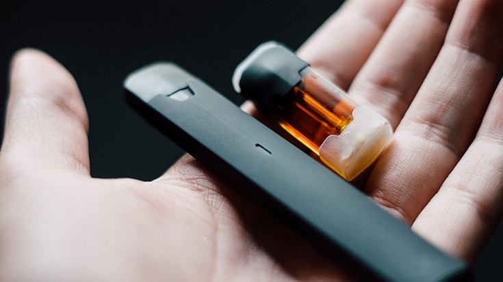 photo of vaping devices in hand