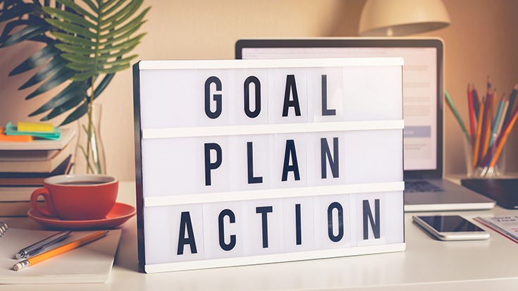view of a desktop with sign that reads goal plan action