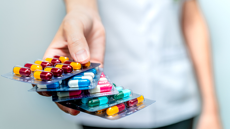 image of medical professional holding various pill packs