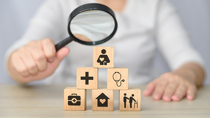 magnifying glass held against blocks of healthcare