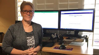 Denita Landsaw standing next to desk