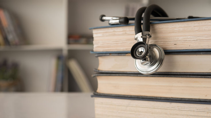 Image of stethoscope on book stack