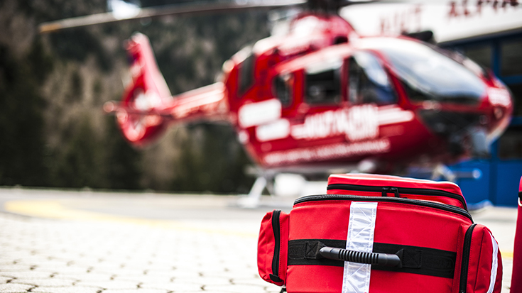 Image of a First Aid medical bag and an emergency helicopter