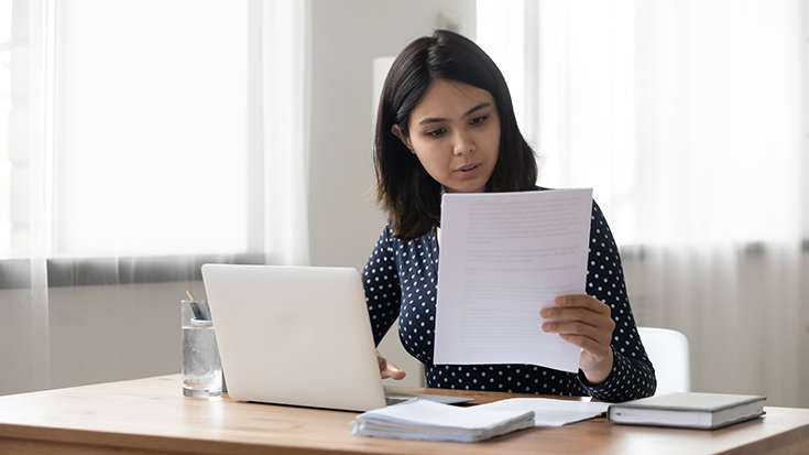 image of woman preparing document on laptop