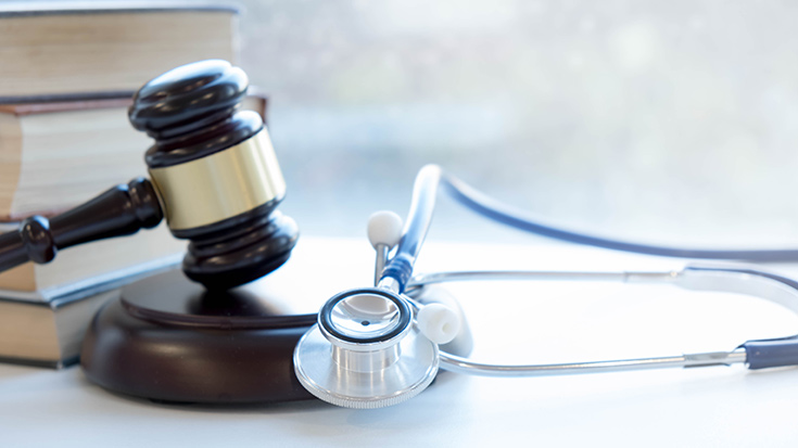 image of gavel and stethoscope with books in background