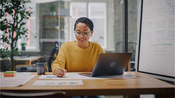 image of woman working at desk
